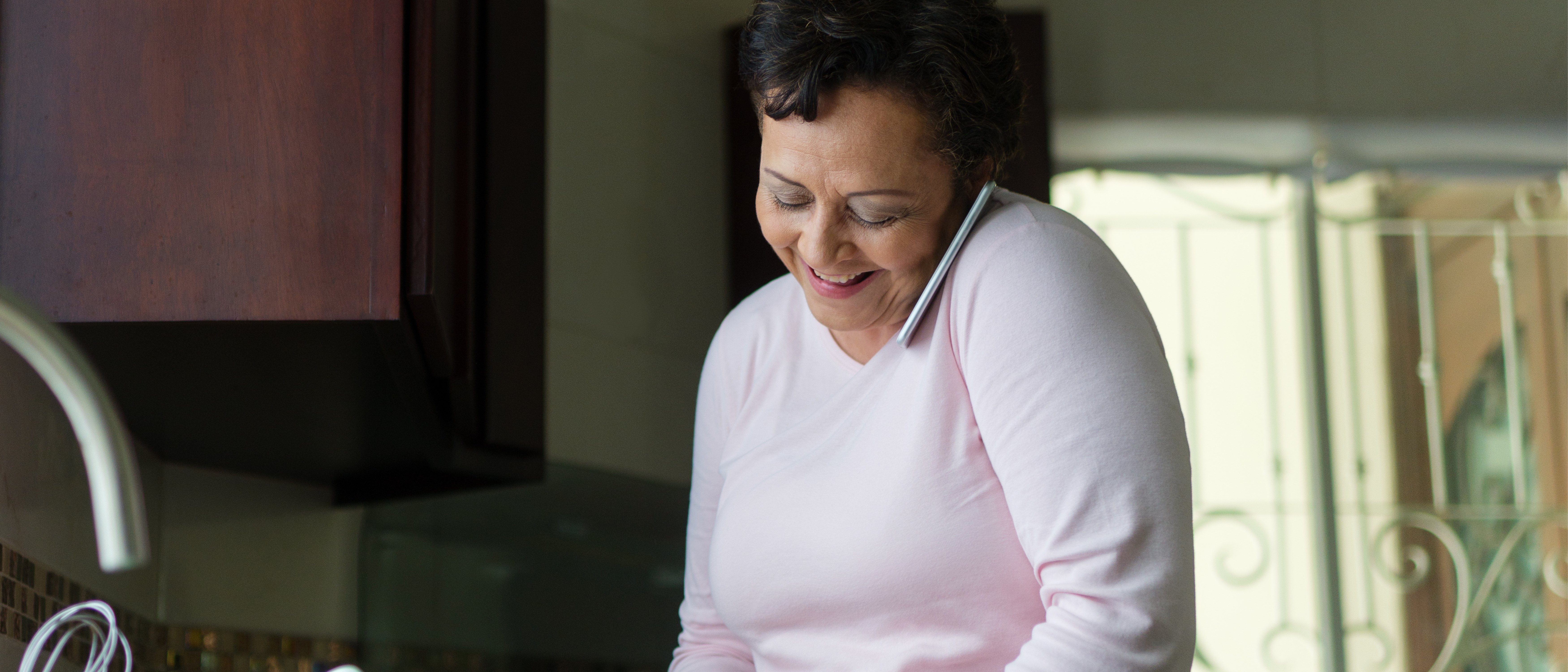 Woman on phone in the kitchen