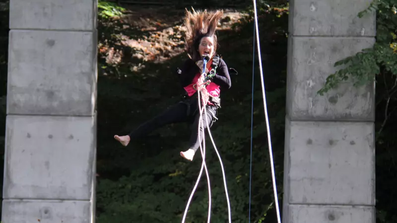 A woman taking part in a bungee swing
