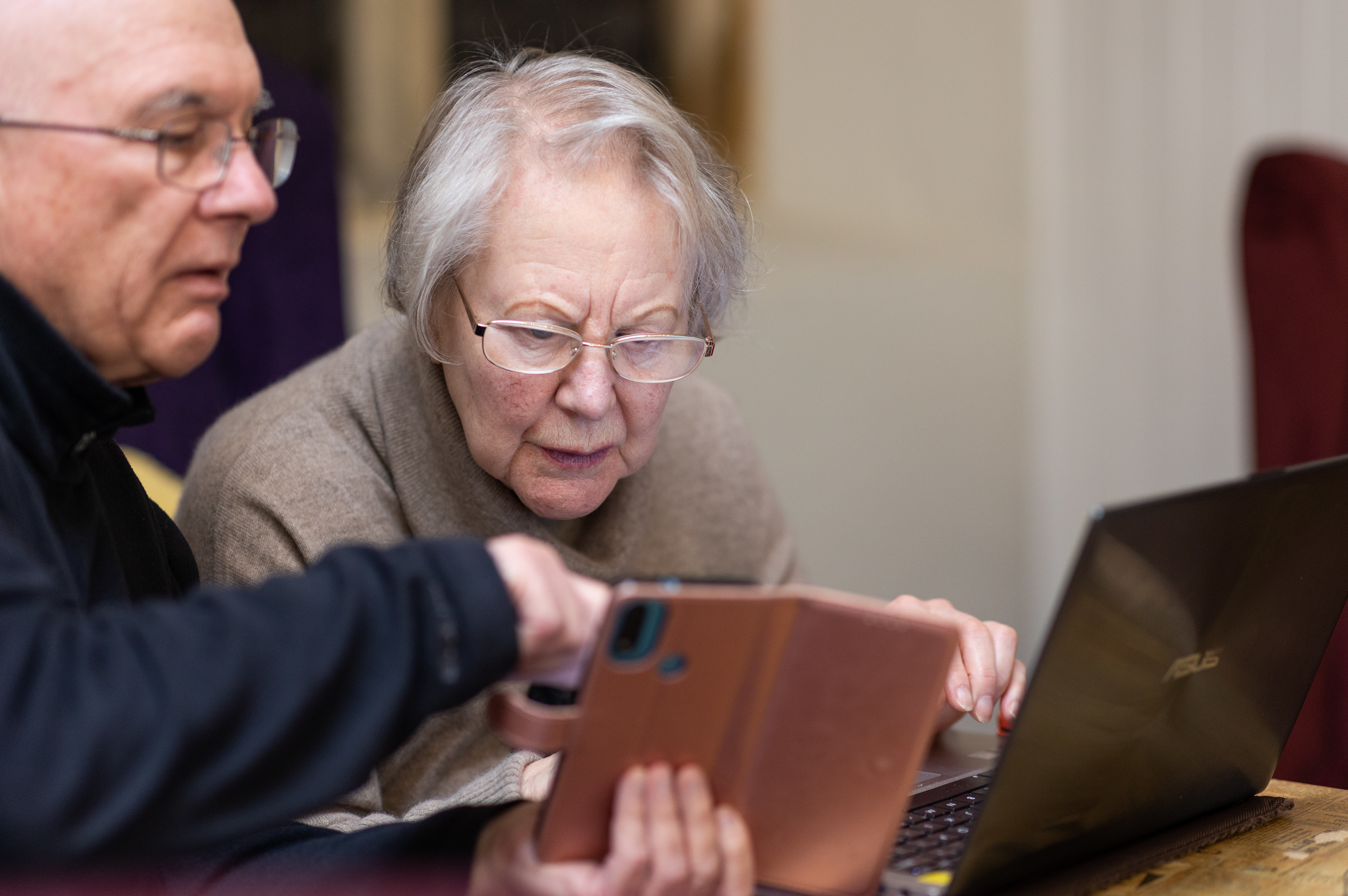 Older couple on smart phone and computers